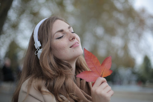 Woman in Autumn Listening to Music